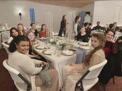 People seated at a decorated banquet table.