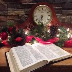 Open book with festive clock and decorations.
