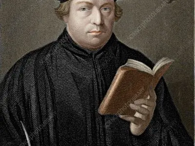 Man in robe holding a book.