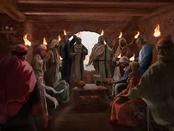 People gathered in a room with torches.