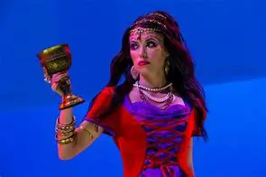 Woman in costume holding ornate goblet.