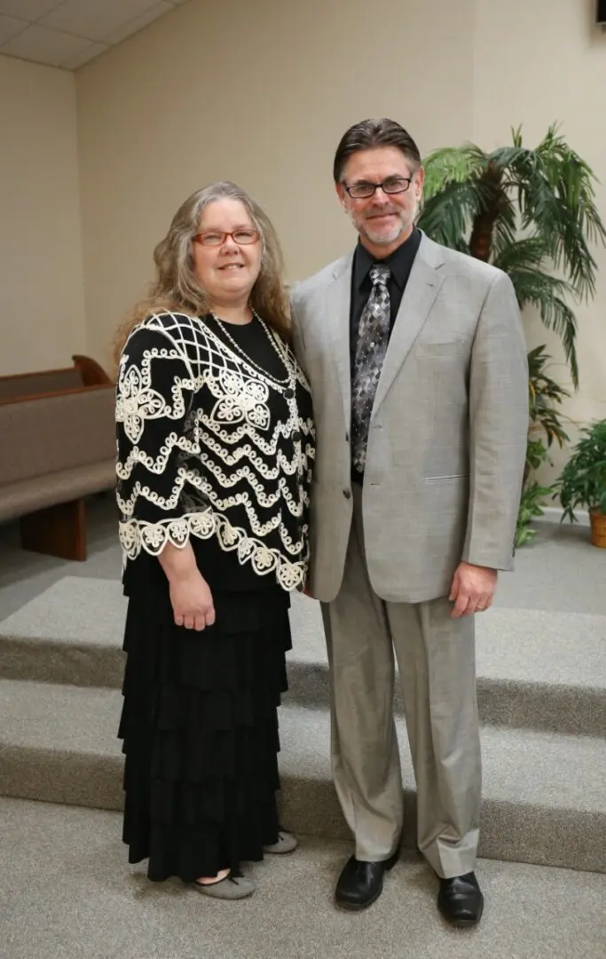 Man and woman posing in formal attire.