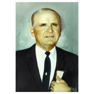 Man in suit holding a book portrait.