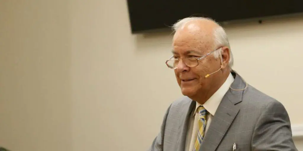 Older man in suit with headset microphone