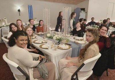 People seated at a decorated banquet table.