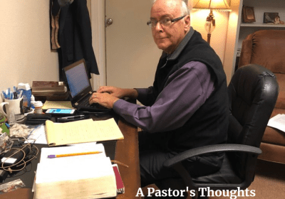 Man working at desk with laptop.