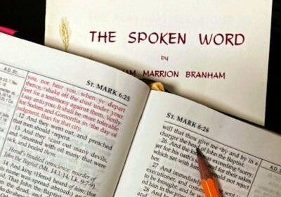 Open book with "The Spoken Word" cover.