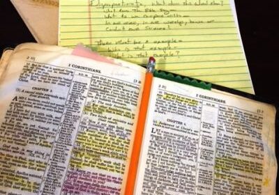 Open Bible with notes and pencil.
